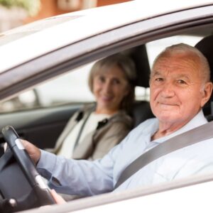 elderly people inside a car