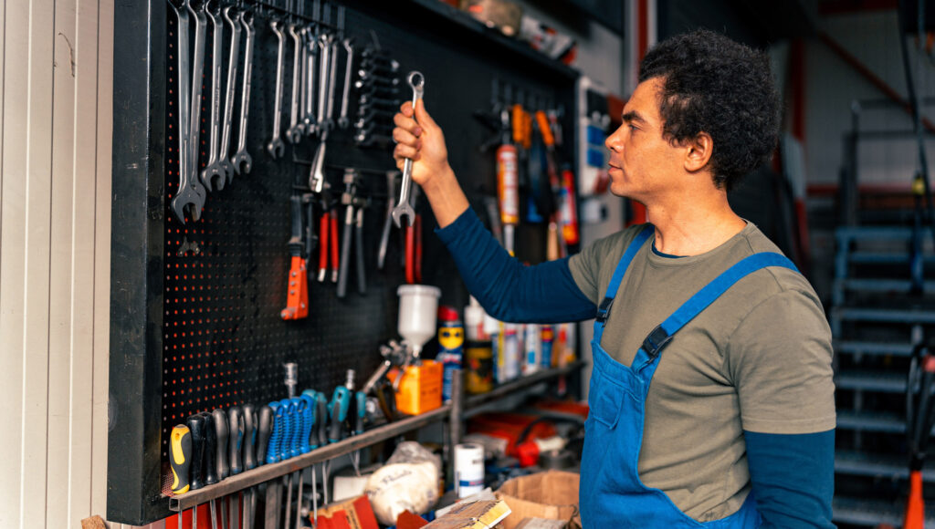 man arranging car garage tools