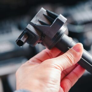 hand holding an automotive ignition coil