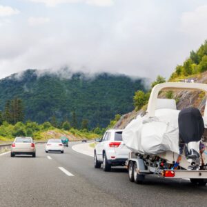 vehicle towing a trailer on a highway