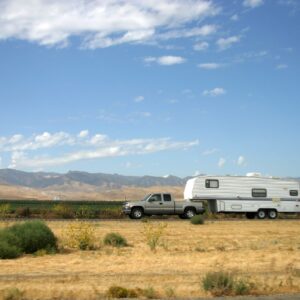 truck towing a trailer in the middle of nowhere