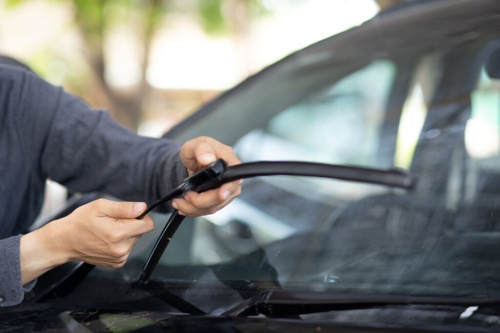man replacing wiper blades