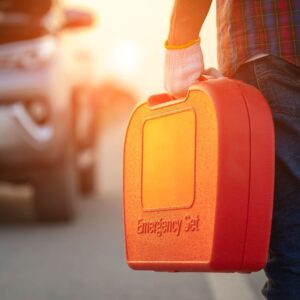 man holding an emergency car tool kit