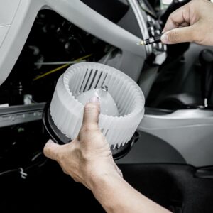 mechanic installing a blower motor