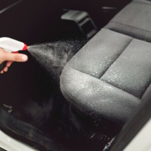 spraying a car interior cleaner