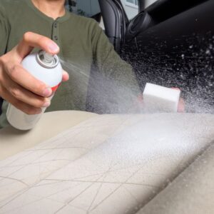 spraying car seat stain remover