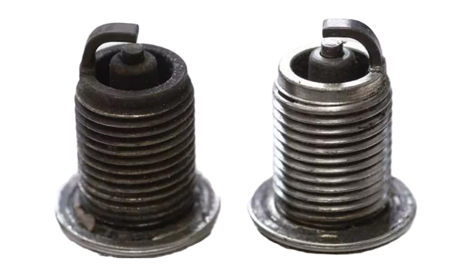 comparison of a spark plug that has turned black and one in better condition
