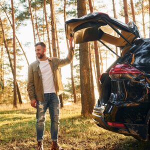 man beside a car in an outdoor setting