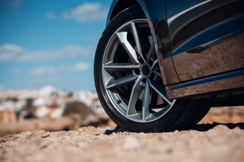 close up shot of a car tire on a rocky surface