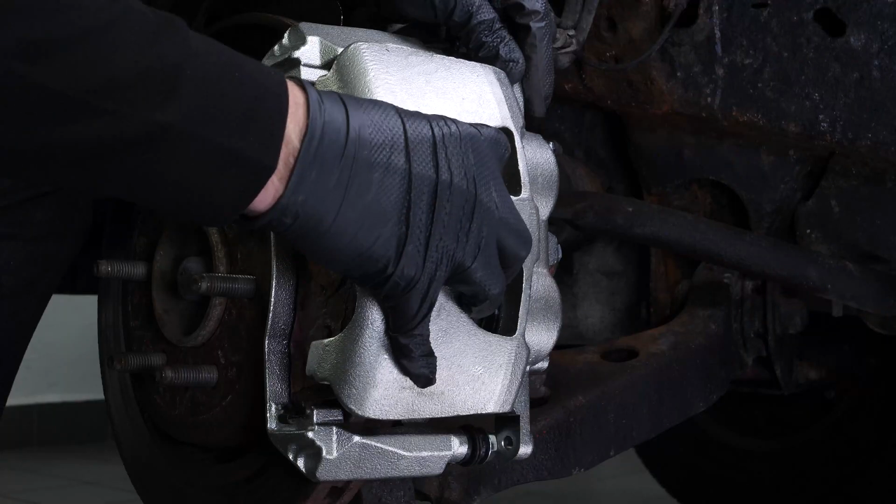 Hang the brake caliper on the strut