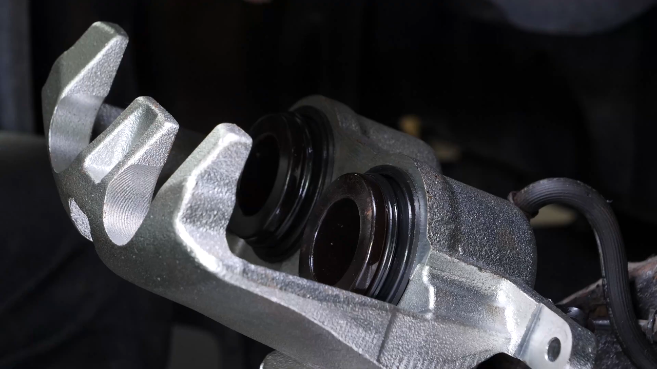 Put the brake caliper back