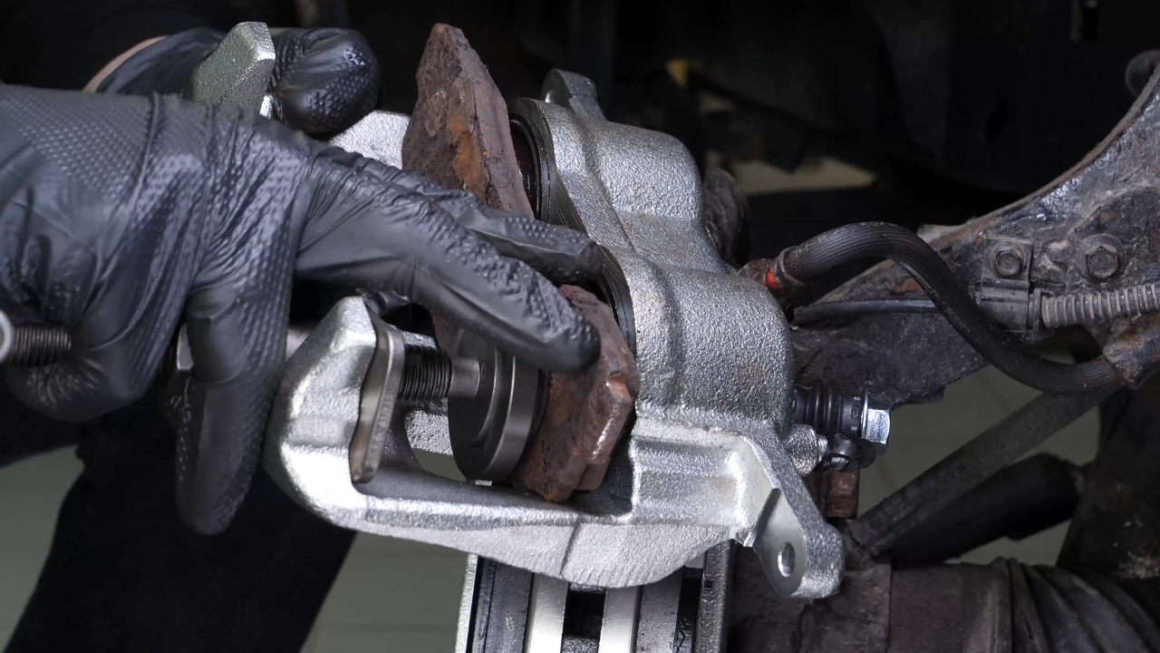 Put the brake caliper back