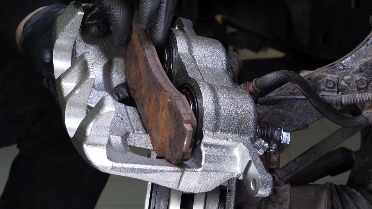 Put the brake caliper back