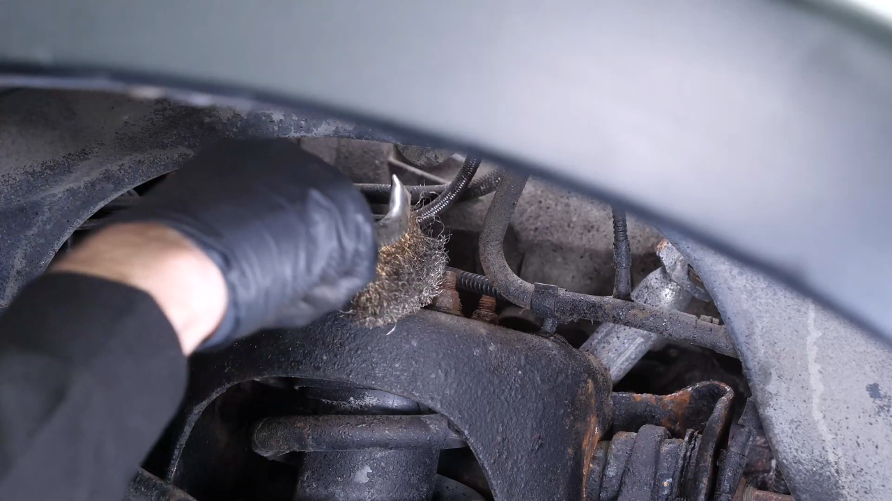 Unscrew the strut mount bearing nuts