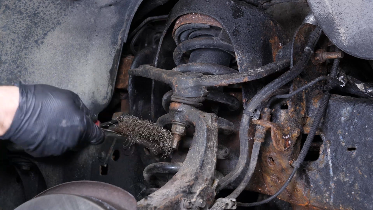 Unscrew the upper control arm ball joint nut