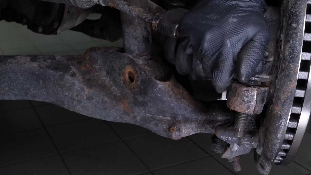 Unscrew the upper control arm ball joint nut