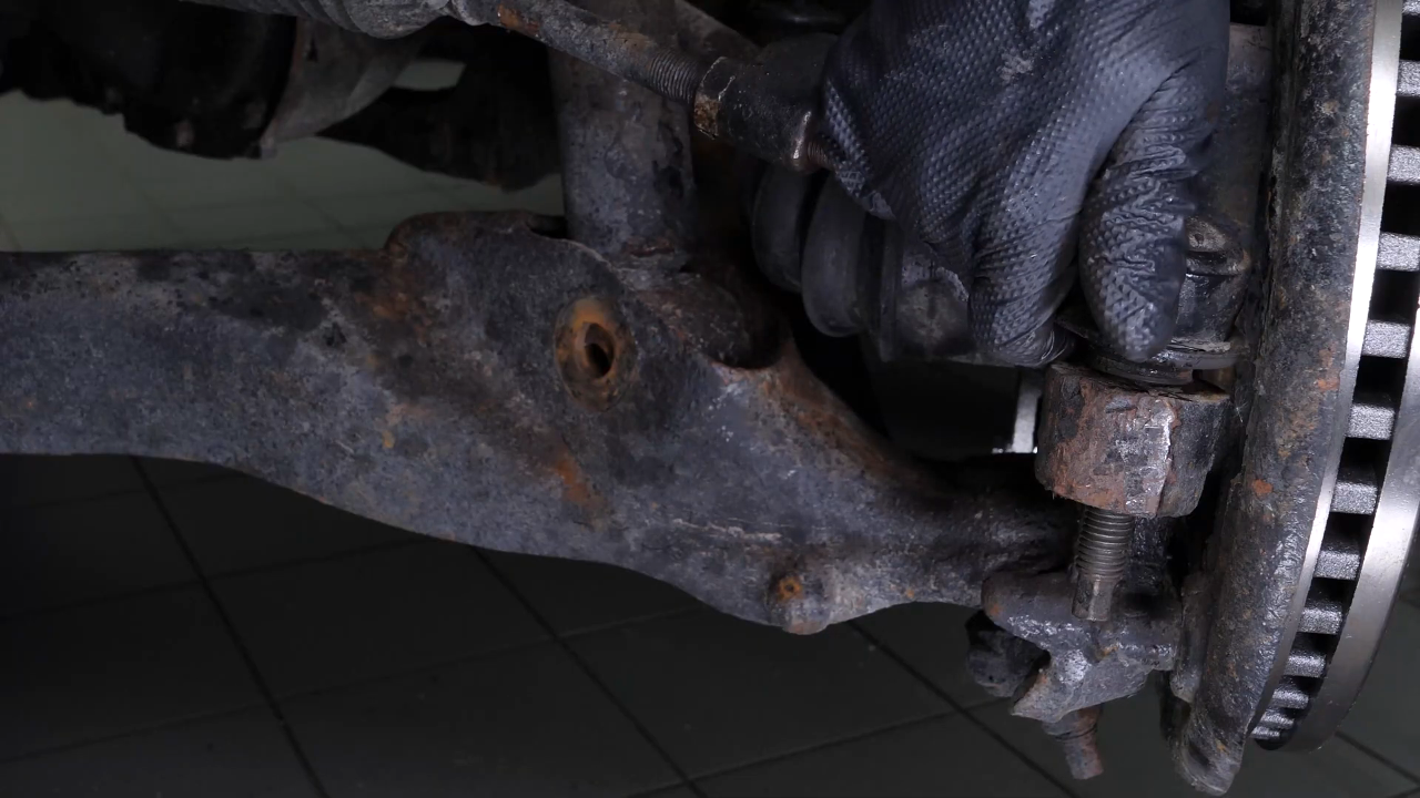 Unscrew the upper control arm ball joint nut
