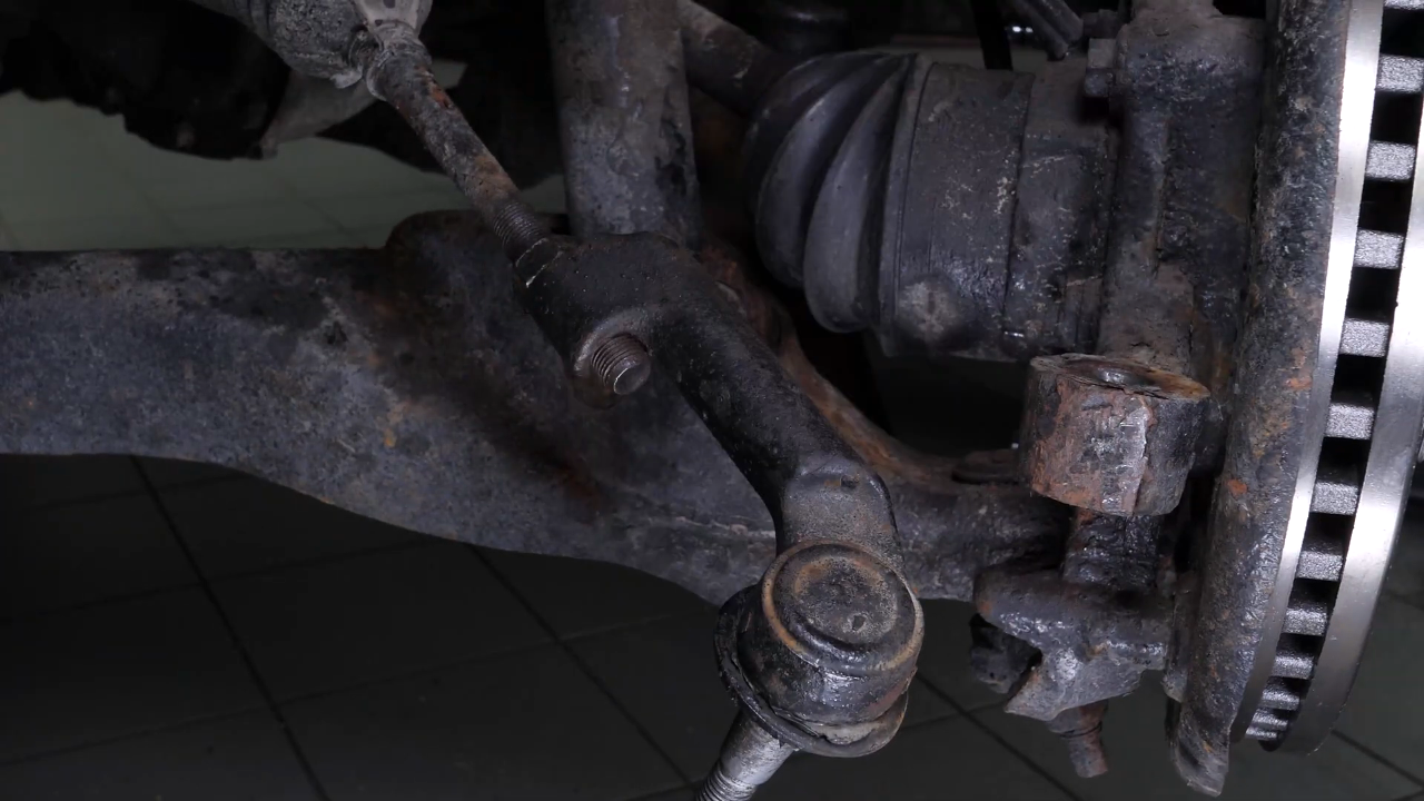 Unscrew the upper control arm ball joint nut