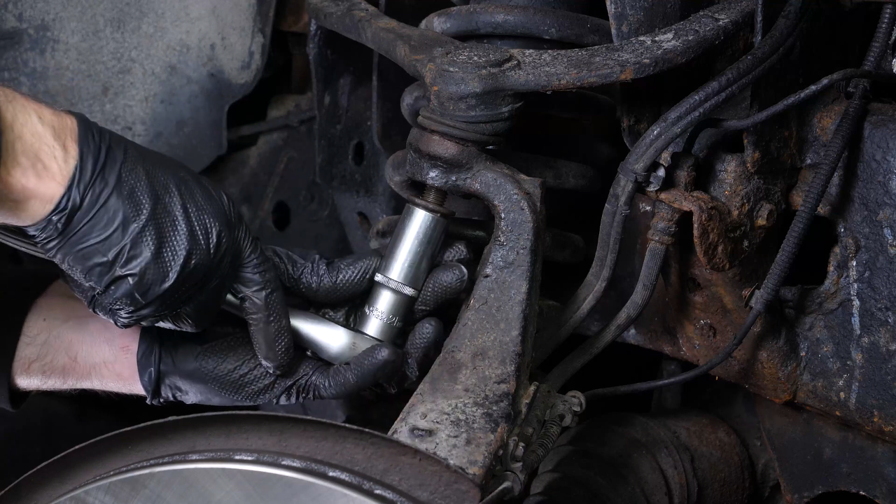 Unscrew the upper control arm ball joint nut