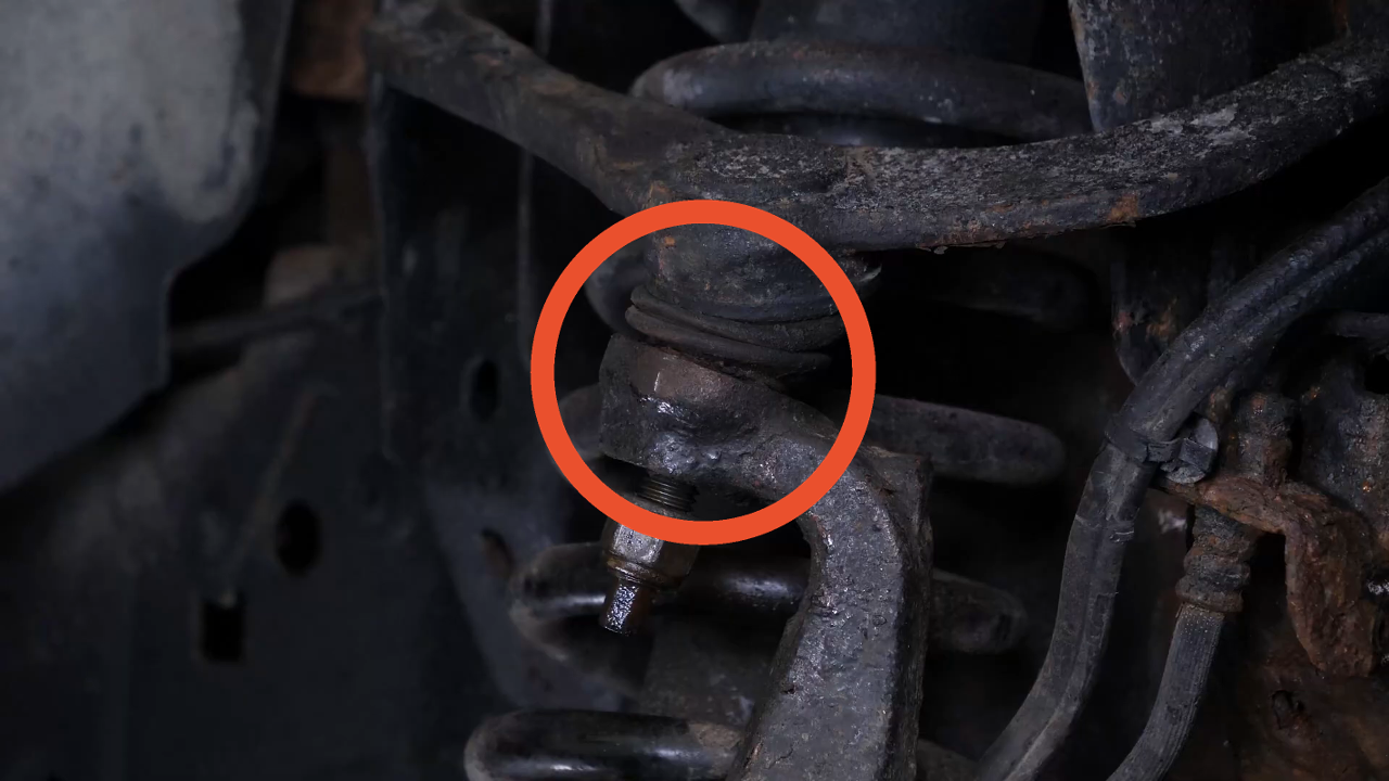 Unscrew the upper control arm ball joint nut