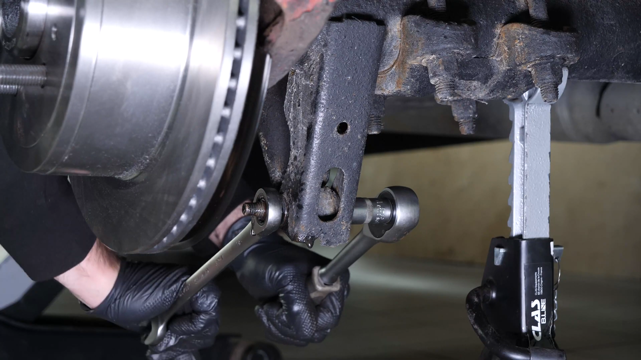 Unscrew the shock absorber foot