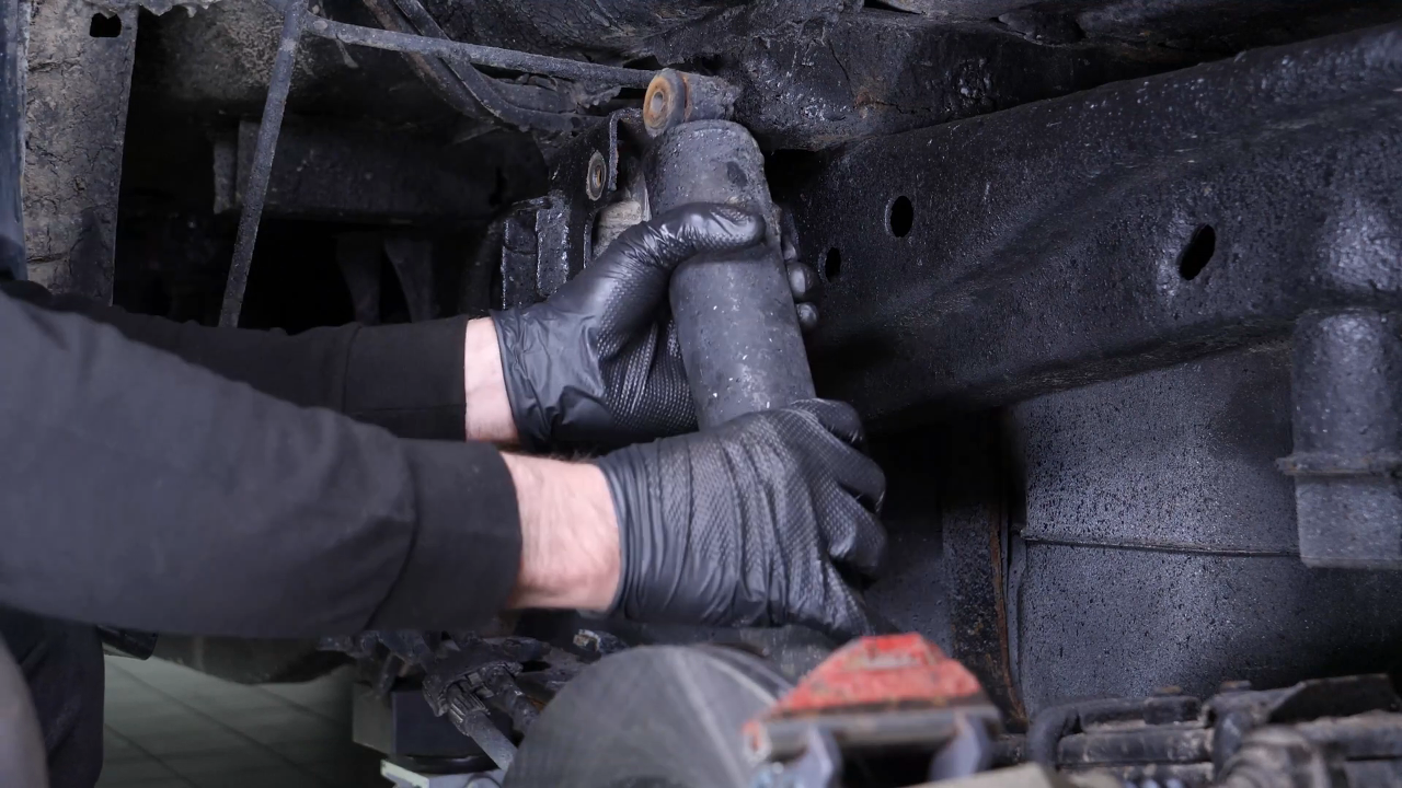 Unscrew the shock absorber foot