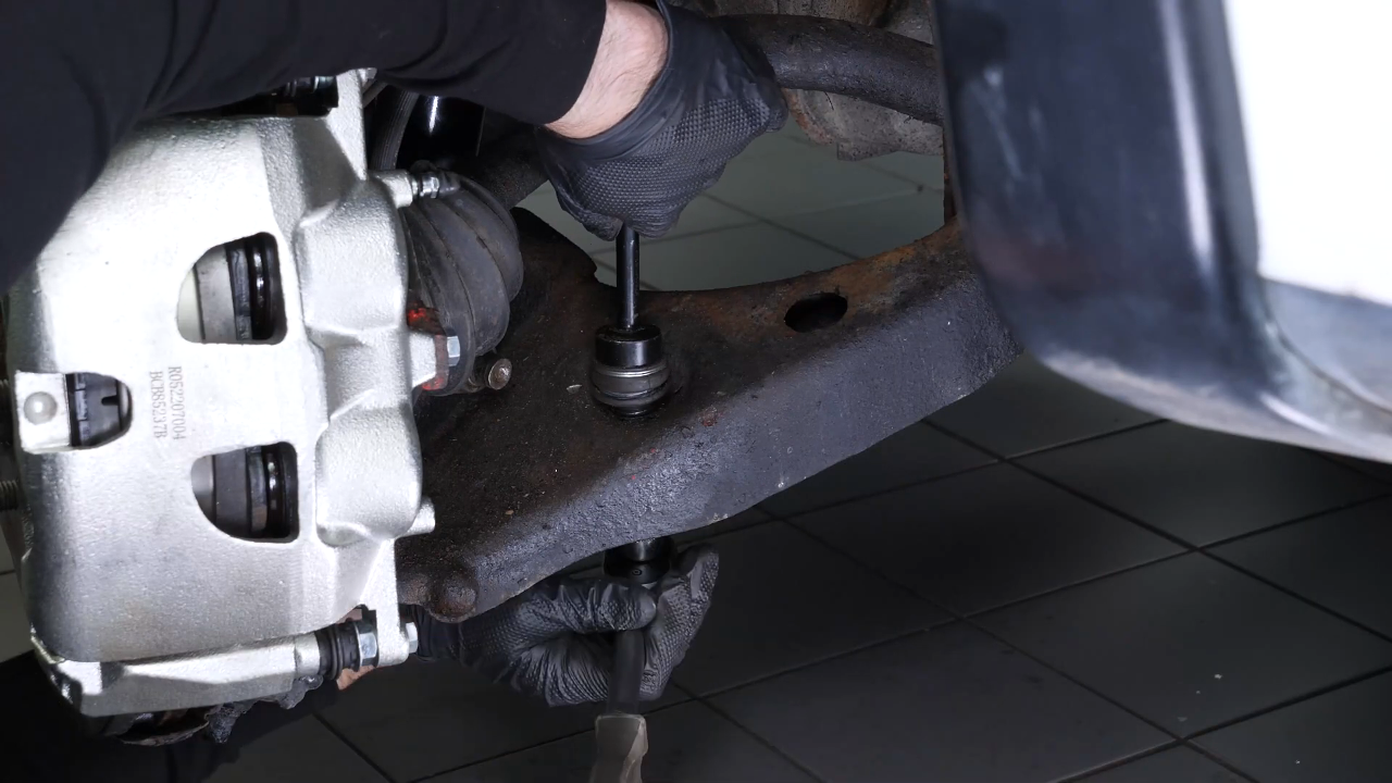 Unscrew the lower ball joint