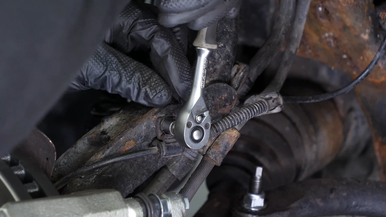 Disconnect the ABS sensor and brake hose connectors