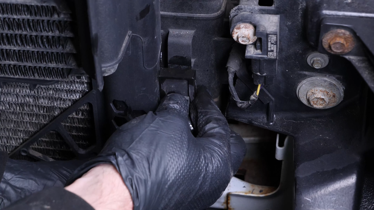 Unclip the air conditioning condenser from the radiator