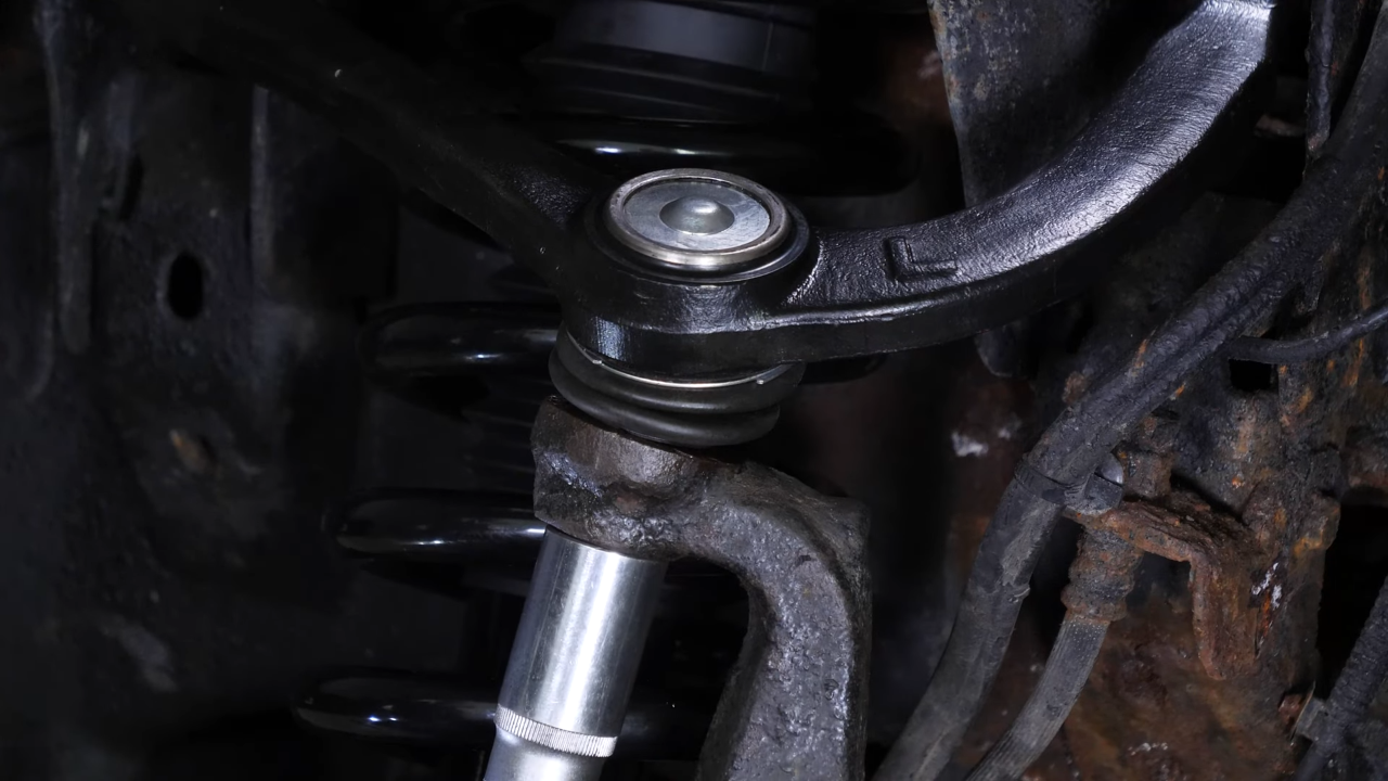 Screw the control arm ball joint nut back