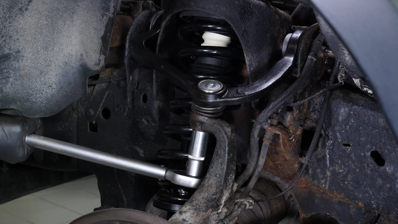 Screw the control arm ball joint nut back