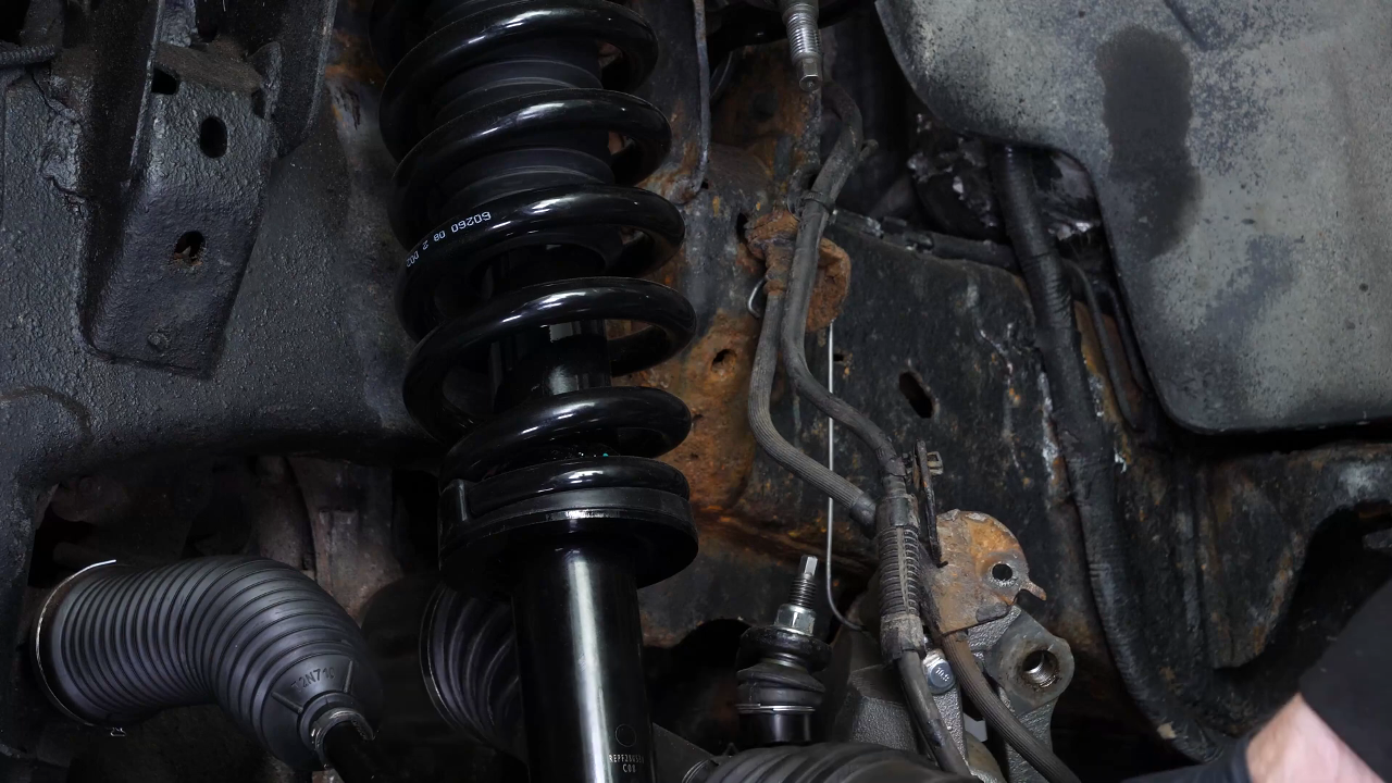 Screw the control arm ball joint nut back