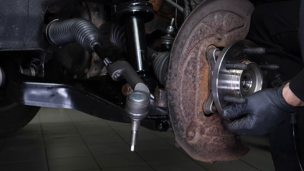 Screw the control arm ball joint nut back
