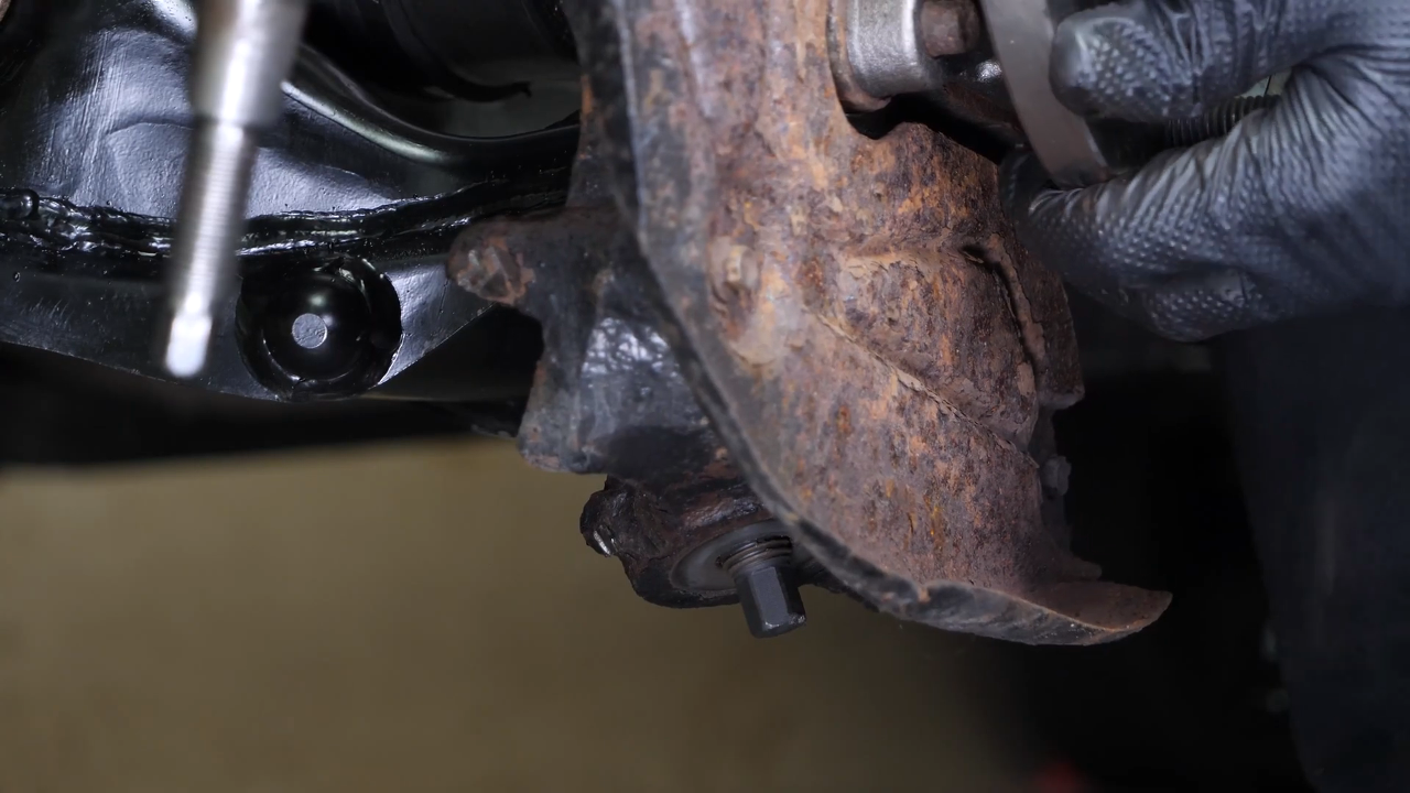 Screw the control arm ball joint nut back