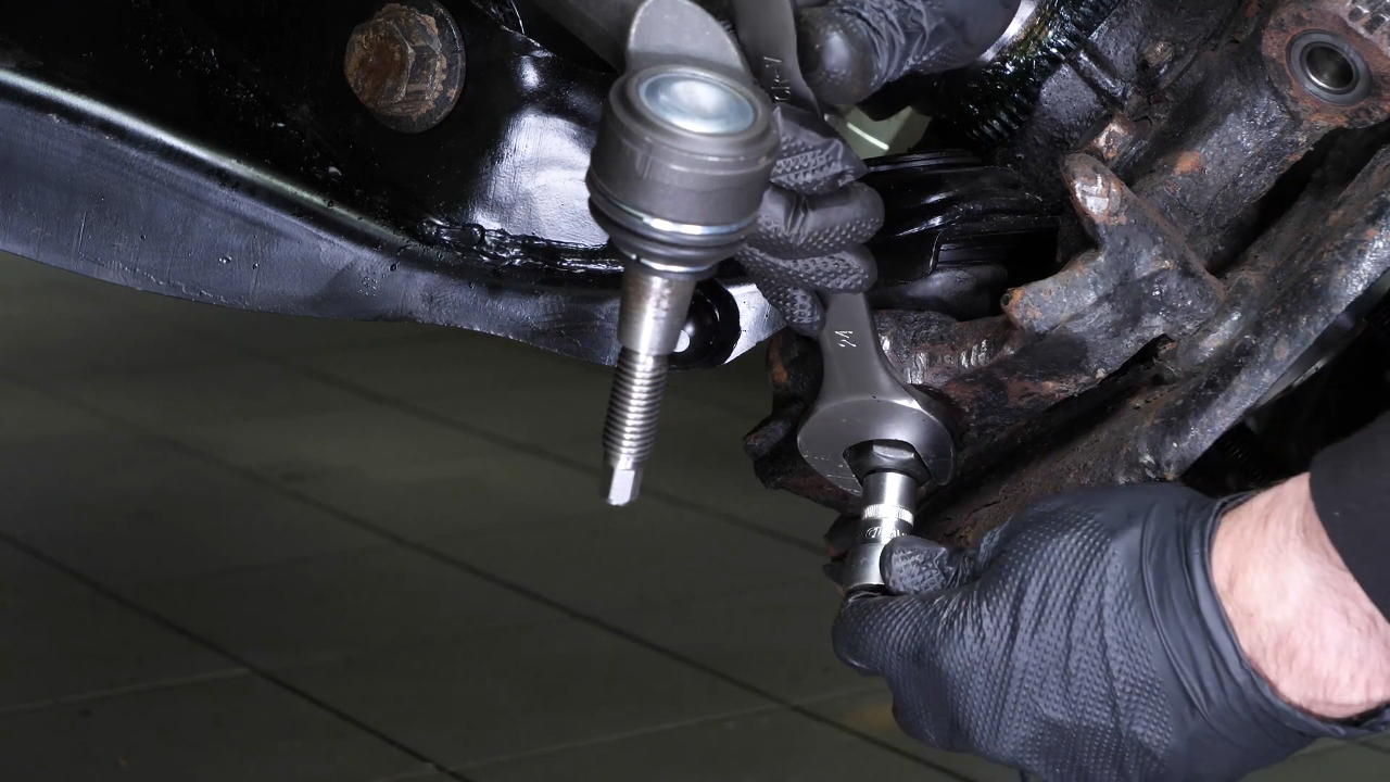 Screw the control arm ball joint nut back