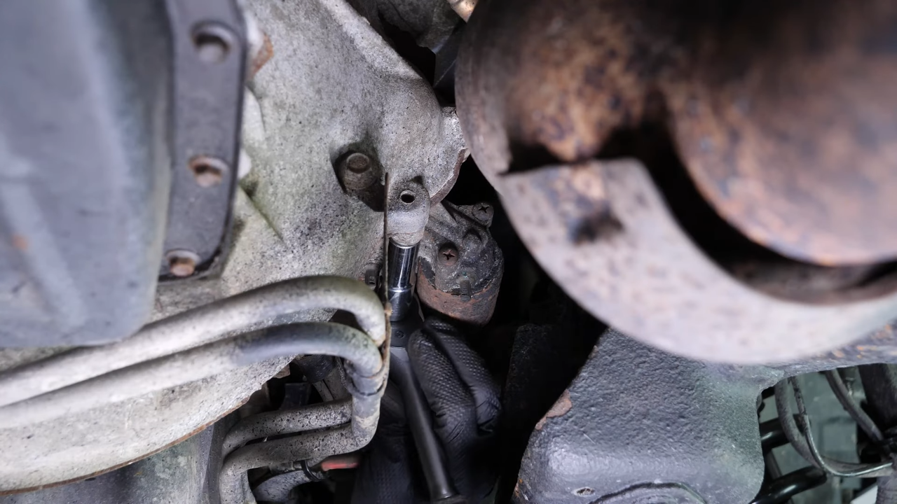 Remove the bolts holding the starter