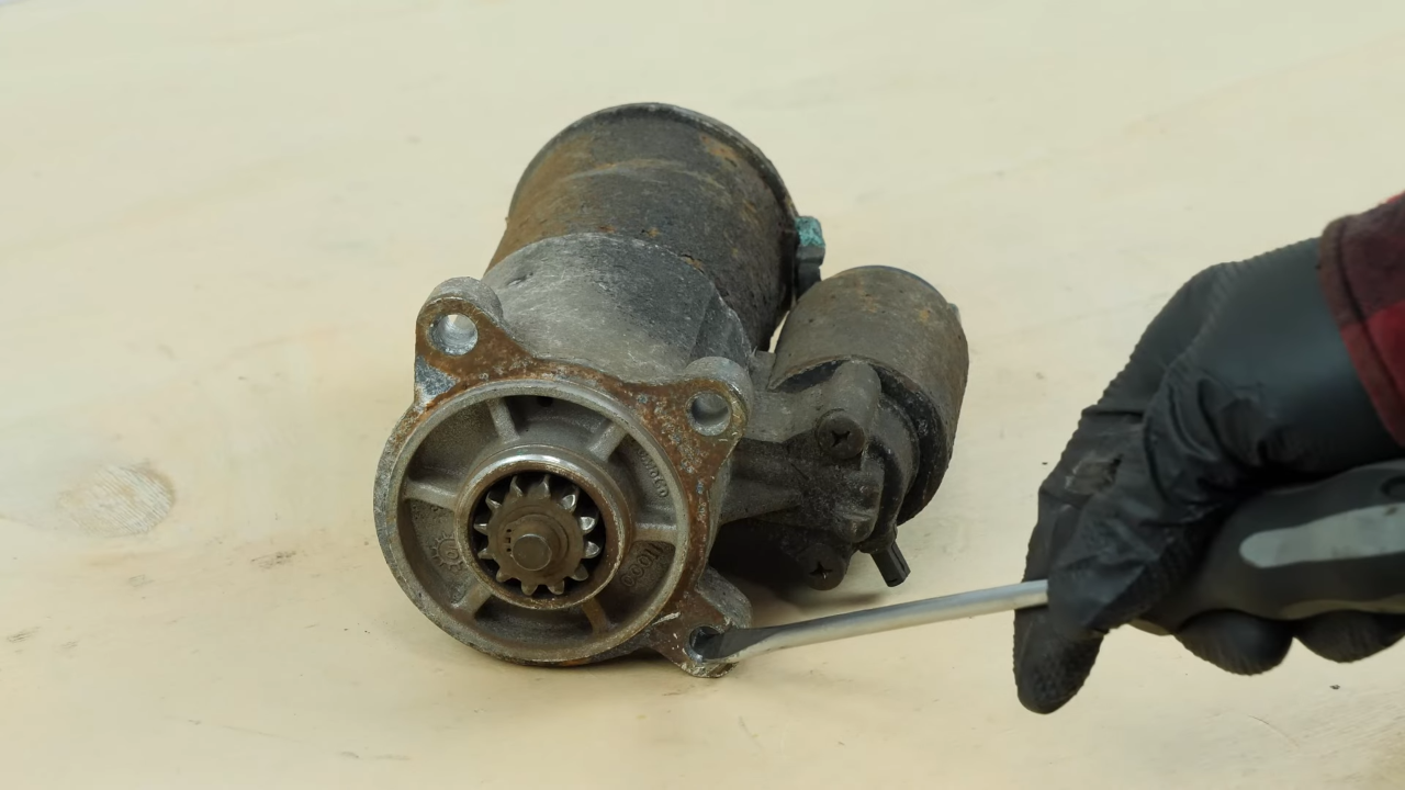 Remove the bolts holding the starter