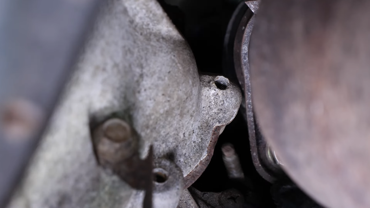 Remove the bolts holding the starter