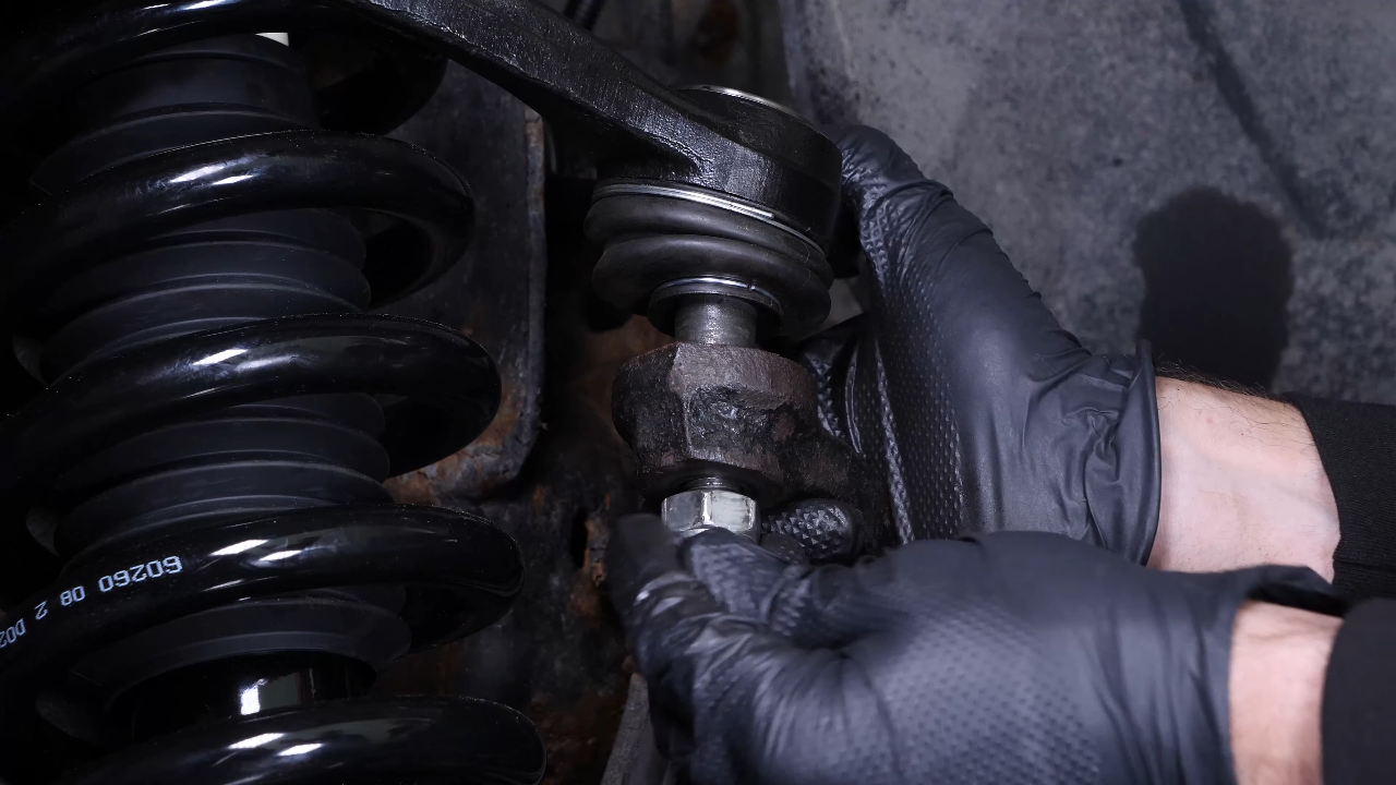 Screw the control arm ball joint nut back