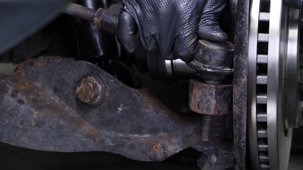 Screw the control arm ball joint nut back