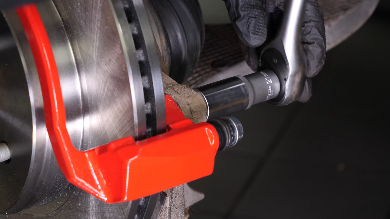 Put the brake caliper mount back on