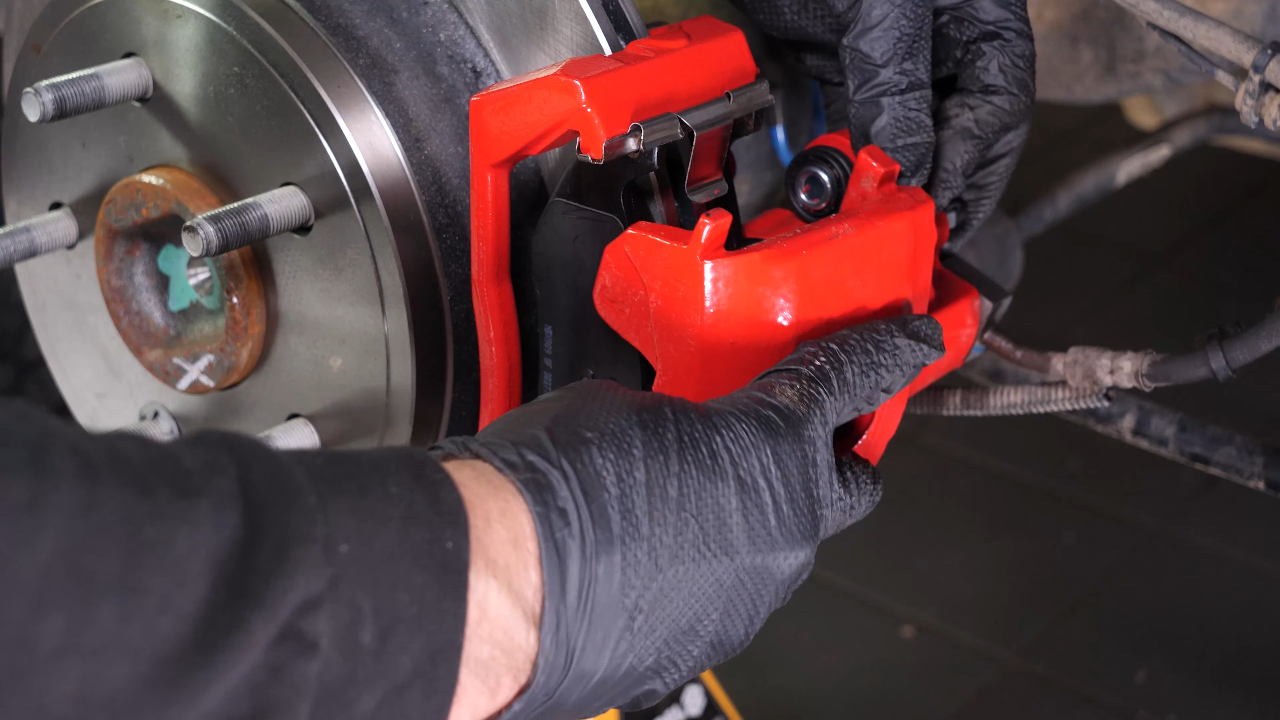 Put the brake caliper back