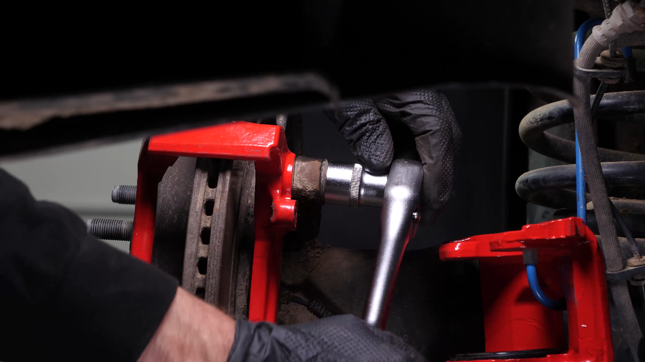 Remove the brake caliper mount