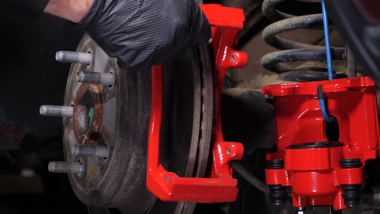 Remove the brake caliper mount