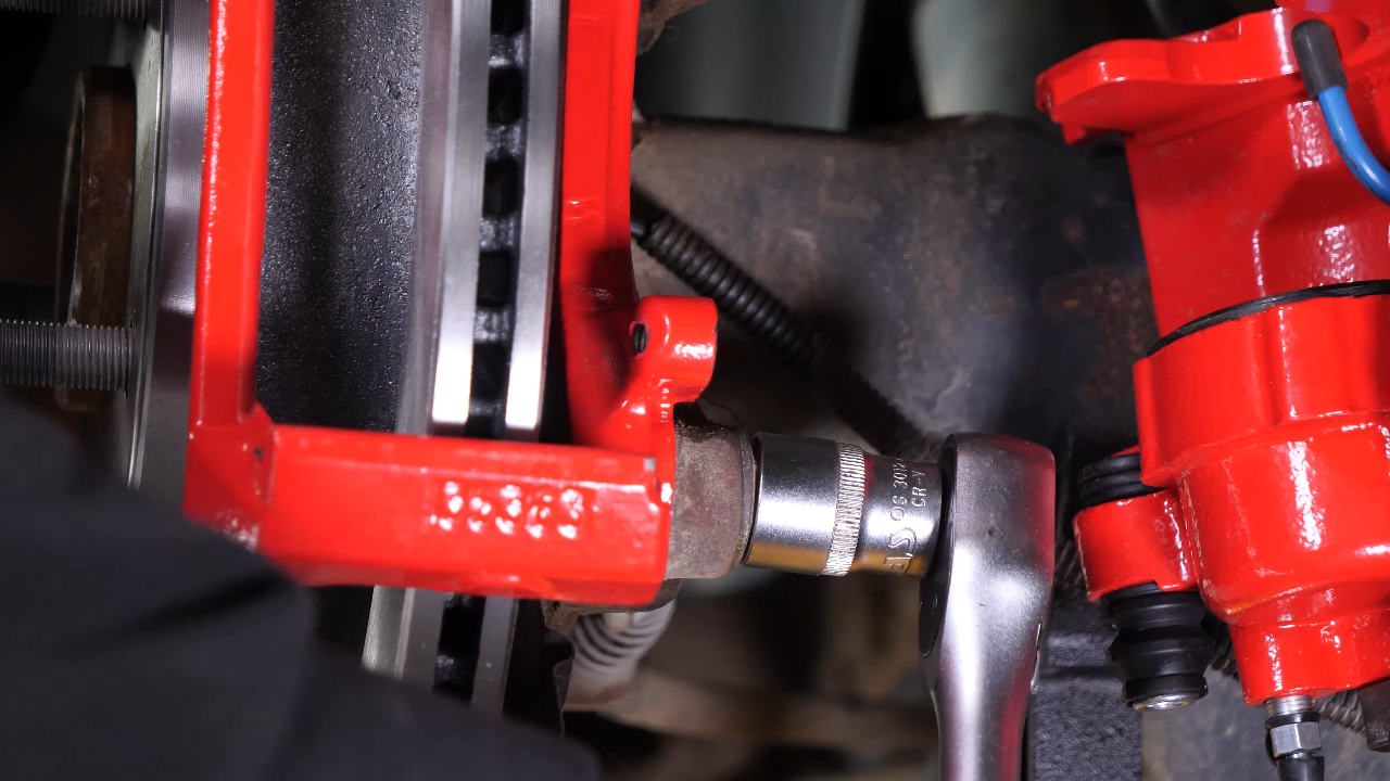 Put the brake caliper mount back on