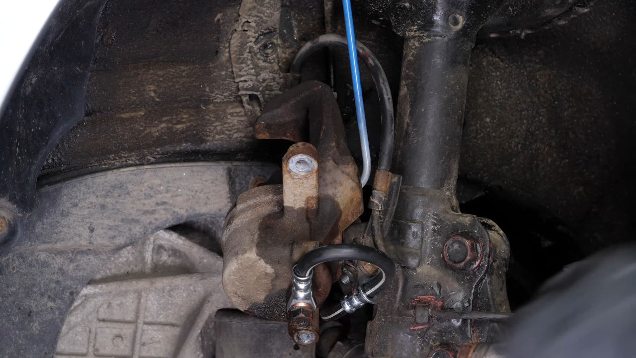 Hang the brake caliper on the strut