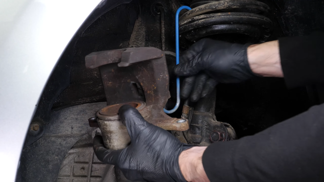 Put the brake caliper back