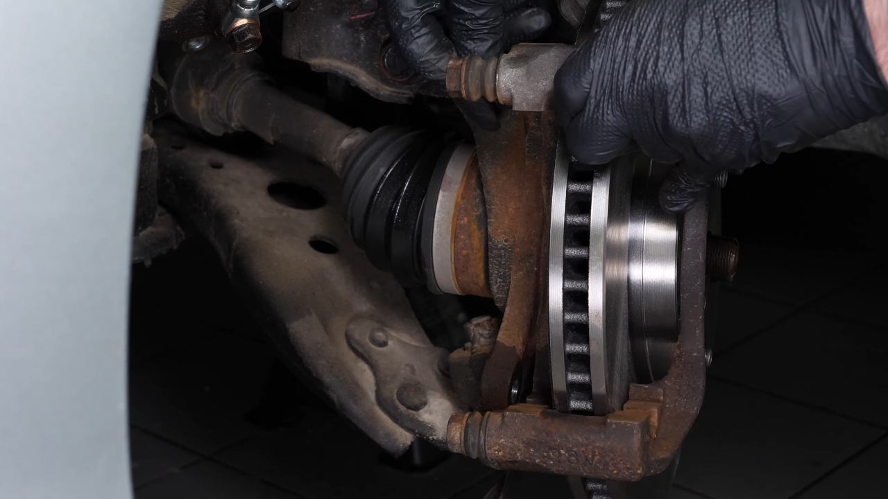 Put the brake caliper mount back on