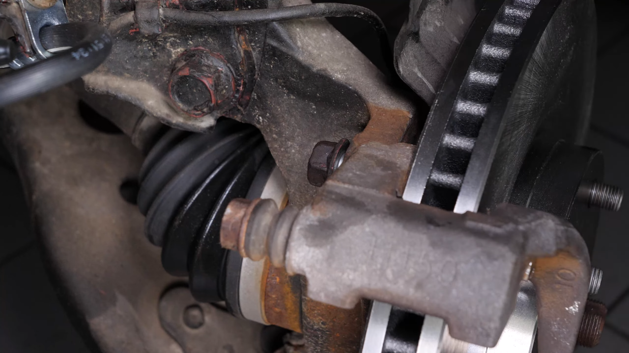 Put the brake caliper mount back on