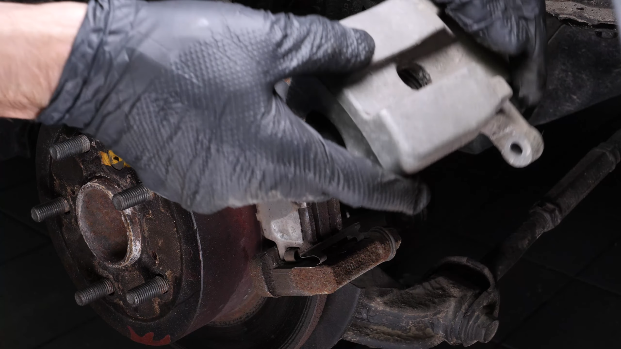 Hang the brake caliper on the strut